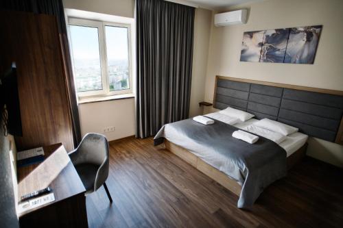 a hotel room with a bed and a window at Nesvit Hotel in Kyiv