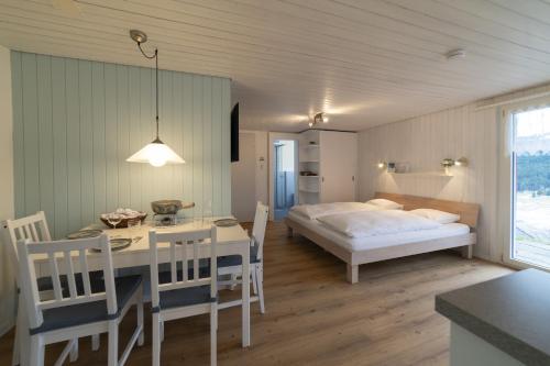 a bedroom with a bed and a table and chairs at Studio Muerner in Wildhaus