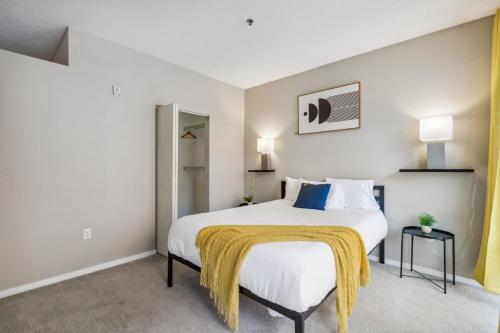 a bedroom with a large bed with a blanket on it at CozySuites Mill District with pool, gym #02 in Minneapolis