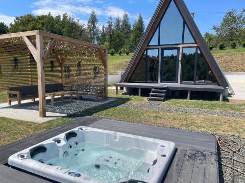 a jacuzzi tub in front of a house at Harmony Cottage - Private Jacuzzi & Nature in Banja Luka