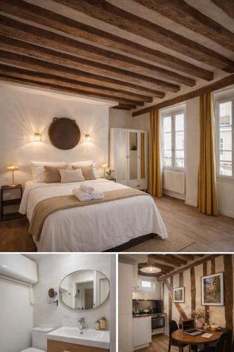 une chambre avec un grand lit et un miroir dans l'établissement Sweet Home, à Paris