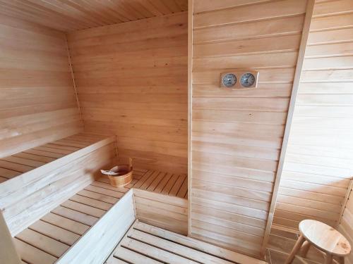 a wooden sauna with a bench and a chair at Chalupa u Vitalky in Klokočí