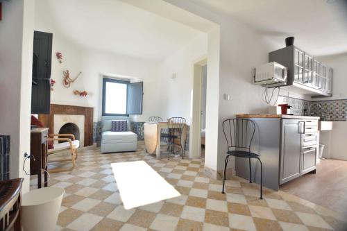 a living room with a kitchen and a dining room at Casota in Sintra