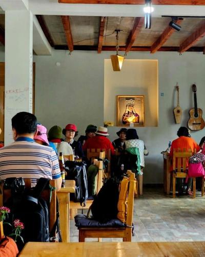 a group of people sitting in a room with guitars at Hotel-restaurant Stumari in Ushguli