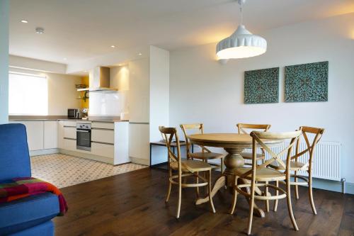 a kitchen and dining room with a table and chairs at Kinsale in Kinsale