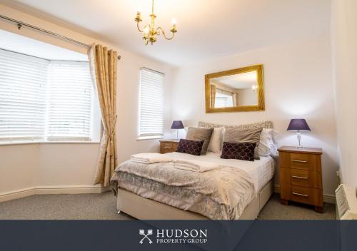 a bedroom with a bed with a mirror and a window at Shrewsbury Apartment in Prime Location in Shrewsbury