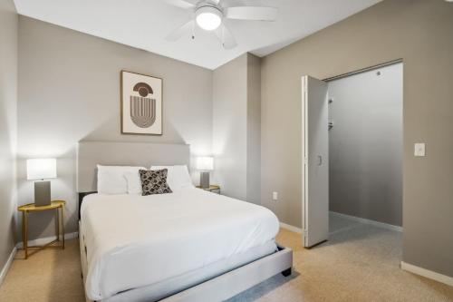 a bedroom with a large white bed and two lamps at CozySuites 2BR Mill District with gym # 01 in Minneapolis