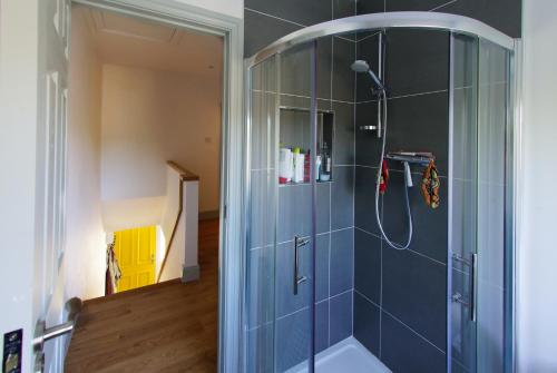 a bathroom with a shower with a glass door at Kinsale in Kinsale