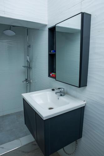 a bathroom with a sink and a mirror at Salama Blue Lodge in Lusaka