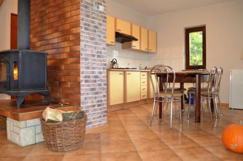 a kitchen with a fireplace and a table and a stove at Dom na Mosornym Groniu in Zawoja