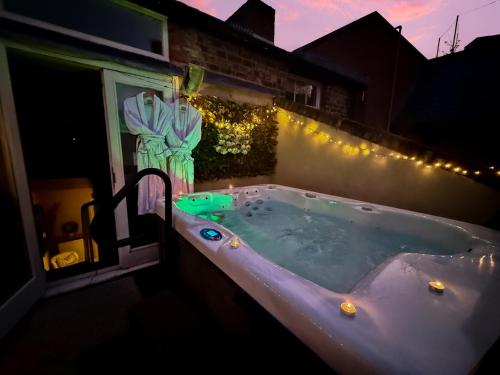 a jacuzzi tub on the side of a house at night at Chester Apartments in Chester