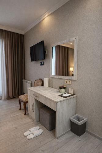 a hotel room with a vanity and a mirror at Urban Nest old Tbilisi hotel in Tbilisi City