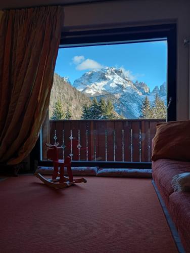 a room with a large window with a mountain view at CAMPIGLIO Panorama sul Brenta in Madonna di Campiglio