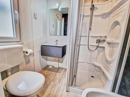 a bathroom with a toilet and a sink and a shower at Villaggio Camping delle Rose - Gatteo a Mare in Gatteo a Mare