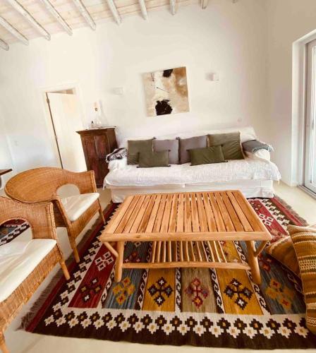 a living room with a bed and a table at Pego Beach House in Grândola