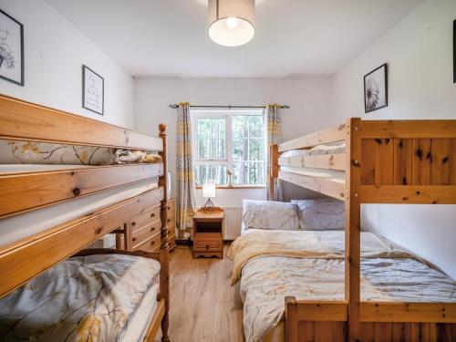 a bedroom with two bunk beds and a window at 2 Bed in Dunkineely oc-ii05062 in Dunkineely