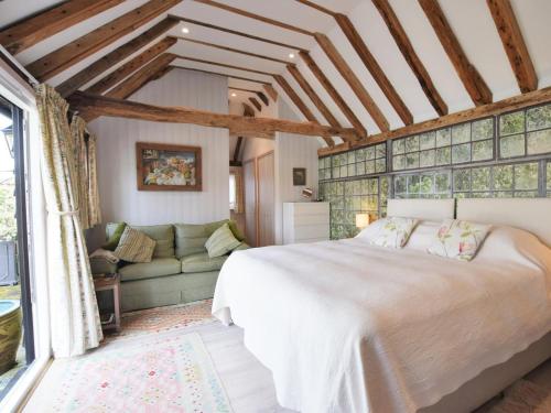 a bedroom with a large bed and a couch at 1 Bed in Ashford oc-bt064 in Biddenden