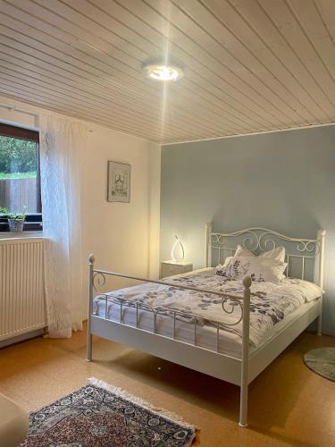 a bedroom with a bed and a window at Gartenblick in Blankenheim