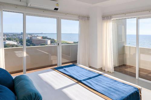a living room with a view of the ocean at Corundum Breeze Negombo in Negombo