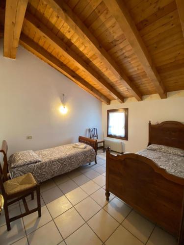 a bedroom with two beds in a room with wooden ceilings at Ca' Del Doge in Caorle