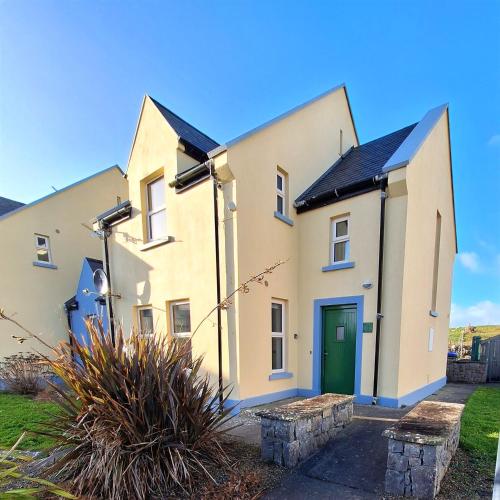 a large white house with a green door at Doolin Court in Doolin