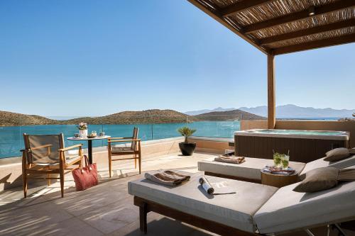 a living room with a view of the ocean at Enorme Infinity Elounda - Adults Only in Elounda