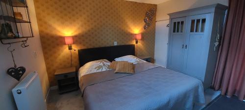 a bedroom with a bed with a book on it at Het Nachtegaaltje in Surhuisterveen