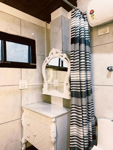 a bathroom with a sink and a mirror at Kavi's Vacation Homes - Peaceful stay in sainj valley in Sainj