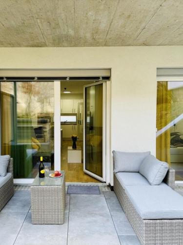 a living room with a couch on a patio at Reload by BestChoice - FREE Parking - Self Check-in in Graz