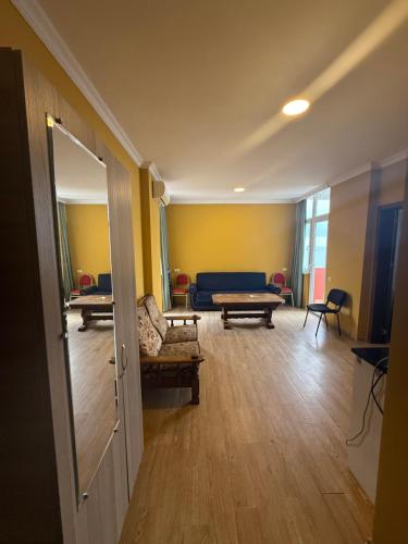 a room with a living room with a couch and a table at у моря in Itʼkhvisi