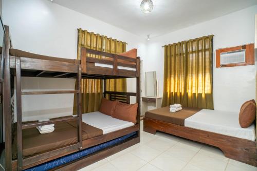 a bedroom with two bunk beds in a room at Prim Travellers Inn in Coron