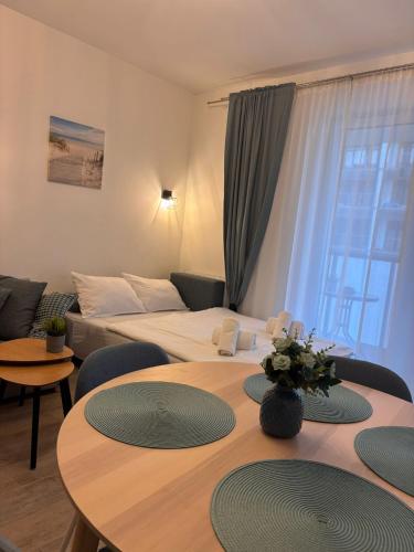 a hotel room with two beds and a table and chairs at Perła Bałtyku - kawalerka z dostępem do Resort &MediSpa in Sianozety