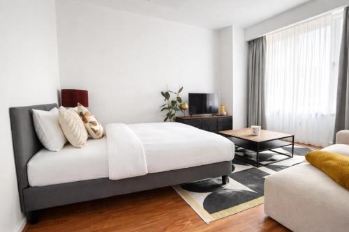 a bedroom with a bed and a living room at 2 Bedroom Apartment for Families and Business, Tram and Bus in Front in Antwerp