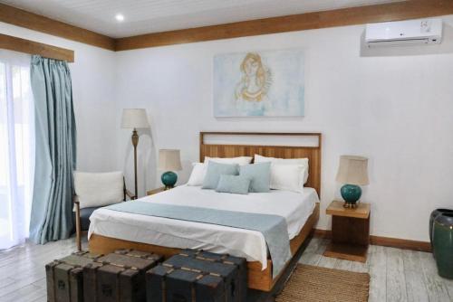 a bedroom with a bed with two suitcases in it at Lakaz Zoizo in Crève Coeur