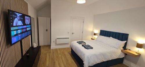 a bedroom with a bed and a flat screen tv at Sullane Weirs in Macroom