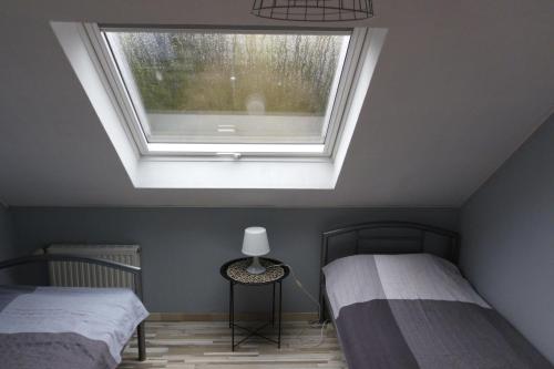 a bedroom with two beds and a window at FeWo-Seestrasse in Diemelsee