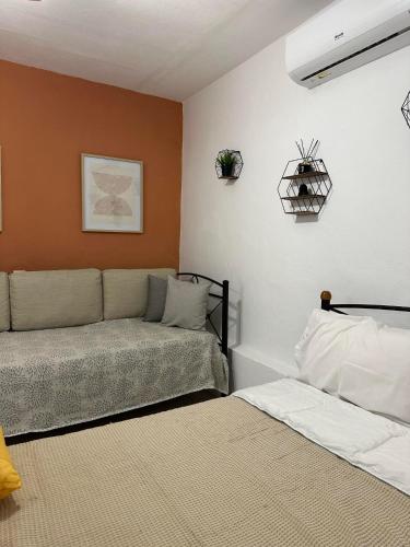 a living room with a couch and a bed at SO SIMPLE mouresi in Mouresi