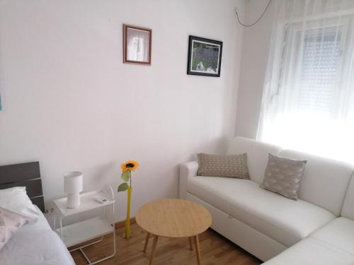 a living room with a white couch and a table at Apartment Zagor Split in Split