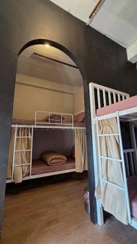 a room with two bunk beds in a room at Zanit Hostel in Don Muang Airport