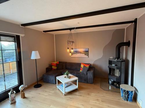 a living room with a couch and a table at Strandgut- unsere Große in Dranske