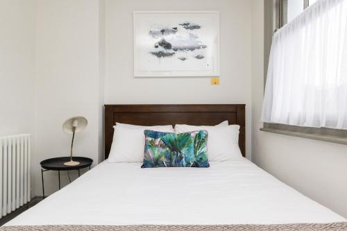 a bedroom with a bed with a pillow on it at Pet-Friendly Luxury Home The Butler Collection in Brighton & Hove