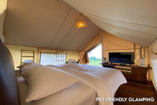 a bedroom with a bed in a tent at Alinson Sunset Hill in Bogor