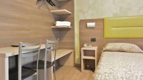 Postel nebo postele na pokoji v ubytování Hotel Siena