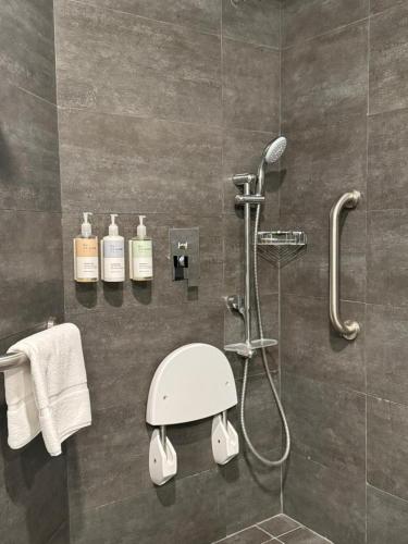 a bathroom with a shower with a shower head at Tulip Inn Majan Hotel and Suites Salalah in Salalah