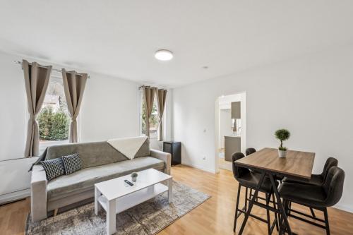 a living room with a couch and a table at Ramoni Apartments - Bad Wildbad in Bad Wildbad