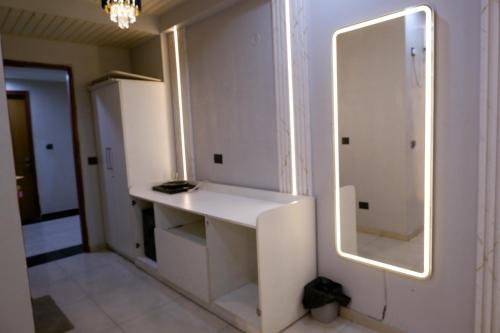 a room with a white desk and a mirror at lucknowi stay in Lucknow