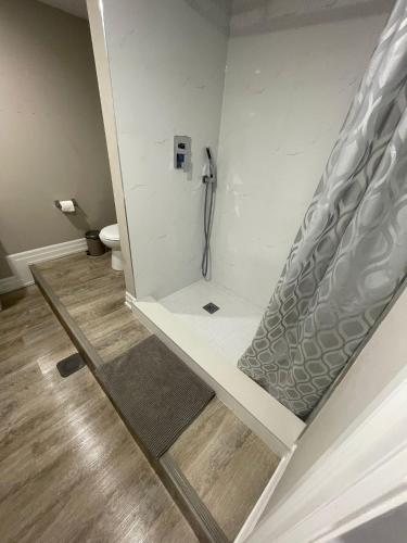 a bathroom with a walk in shower with a toilet at Sweet Home in Bloor Downtown-CENTRAL STAY in Toronto