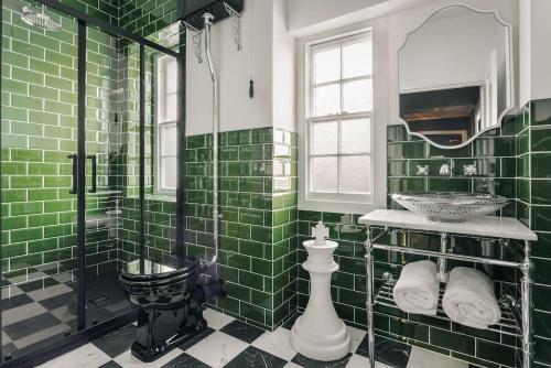a green tiled bathroom with a sink and a shower at Old Earth - Ridgestone in Kendal