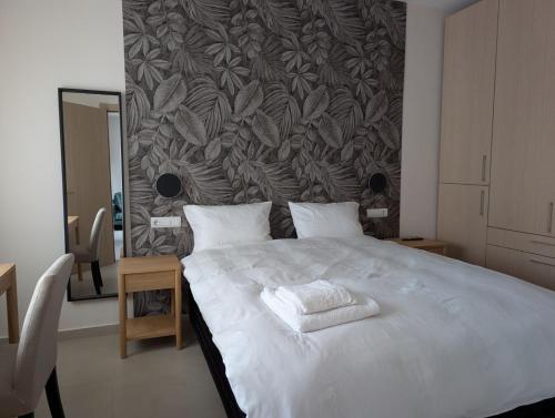 a bedroom with a bed with two towels on it at Ekavis House and Terrace in Kavála