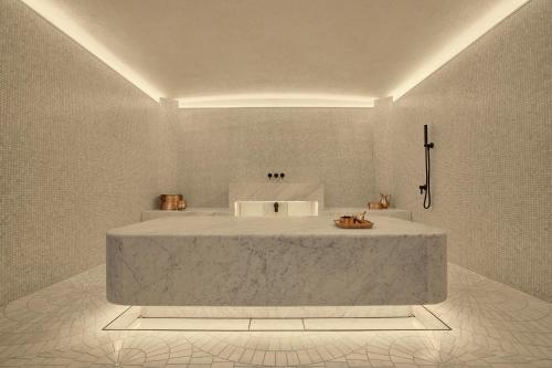 a bathroom with a large tub in a room at Six Senses London in London